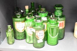 A group of ten Victorian green glass apothecary/chemists bottles, of fluted cylindrical form, five