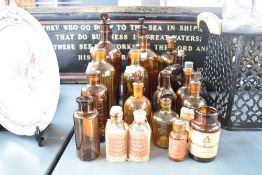 A selection of Victorian apothecary amber-coloured glass bottles, including poison, elixir and