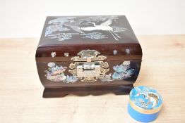 A lacquered oriental jewellery box featuring intricate mother of pearl inlay work, measures 20cm x