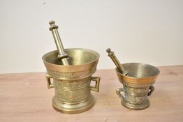 Two Victorian brass apothecary pestles and mortars, each with ornate decoration and of traditional