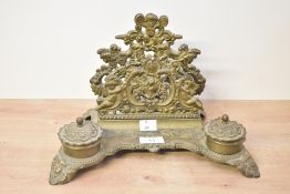 A 20th century French Baroque-style brass double inkwell and letter stand, richly decorated in