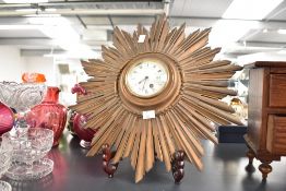 An early 20th-century French-style giltwood Sunburst wall clock, Roman numeral hours set within a
