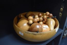 A Parlane turned wooden fruit bowl containing a selection of turned and carved wooden fruit 29.5cm