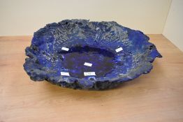 A large studio pottery dish having molten glass effect to centre, diameter measures 40cm.