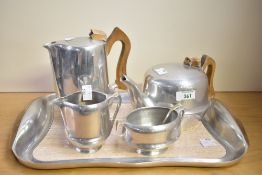 A mid 20th-century magnailium Picquot Ware tea set, featuring sycamore wood handles, to include milk