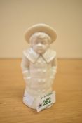 A Royal Worcester fine bone china figurral pepperette depicting a young boy in coat and hat,