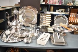 An assortment of silver-plated ware to include salver, coffee pot, berry spoon, butter dish and