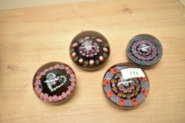 A Paul Ysart millefiori glass paperweight sold together with three other 20th century millefiori