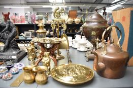 A large assortment of copper and brass ware to include a miniature fire companion set, horse