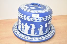 A 20th-century Wedgewood jasperware cheese dome and stand, decorated with classical figures and