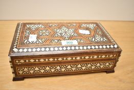 A 20th-century Middle Eastern-style wooden box, featuring mother-of-pearl inlaid decoration, a