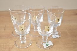 A collection of five 20th-century Cumbria Crystal footed goblets, having smooth bowls and double