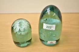 Two Victorian green glass 'dump' paperweights, each with foliate sulphide inclusions, largest 13cm