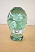 A Victorian green glass 'dump' paperweight with foliate sulphide inclusions, 12.5cm