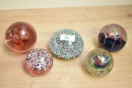 Five 20th-century assorted Art Glass paperweights, including a large colourful millefiori example, a