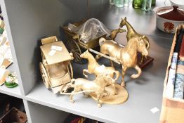 A quantity of late 19th to 20th-century brass horse figurines, including two horse and cart