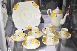 A Collingwoods bone china Art Deco design part coffee set, decorated with stylised yellow flower