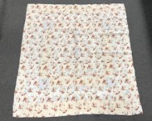 An antique quilt in cream woven cotton with an all-over pink and terracotta leaf pattern, there