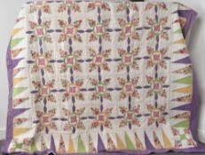 Am 20th century vintage patchwork and applique quilt, having a geometric border enclosing a grid