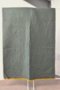 An antique Durham quilt, in rare unused condition, in soft and finely woven forest green fabric,