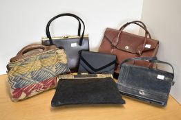 Six vintage handbags, to include a black suede frame handled example with interesting Egyptian