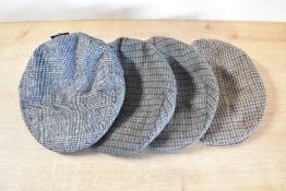 Four flat caps, two green, one tan and a grey.