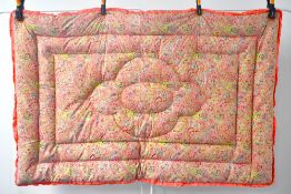 A circa 1930s Paisley Eiderdown blanket, in vibrant pink cotton ground with pastel blue, green,