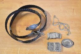 A woven belt, silver tone chain, buckles and cuffs bearing Eastern lettering, needs repair.