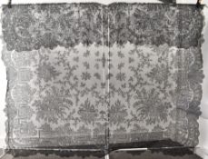 A Victorian lace mourning veil, highly intricate and ornate with foliate and floral design, measures