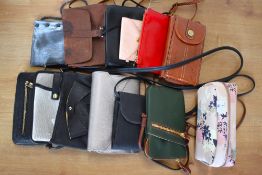 Twelve mini cross-body bags, phone pouches, wallets and combination purses, in a range of colours