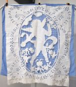 An antique needlework panel featuring a cut-out angel figure, embroidered with grid-lace suspension,