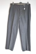 A pair of antique mens trousers, in black fine wool suiting fabric, having front pleats, button fly,