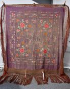 A 19th century Chinese shawl, hand embroidered with ornate floral design in pinks, orange, and