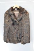 A vintage half length Real Coney fur coat in silky soft brown fur, with wide notch lapels and cool