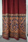 A early 20th century carpeted hanging, drape or curtain in plum velvet feel weave, with a band of