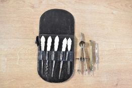 A set of mother of pear handled button hooks, in black case, along with a navigation compass and two