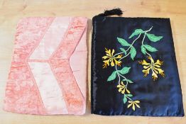 Two 20th century vintage clutch purses or pyjama wallets with padded walls, one black satin with