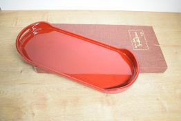 A modern Japanese Urushi Nuri lacquered tray, of rounded oblong form with gilt label verso,