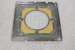 An unusul antique Chinese coloured and etched glass window panel, the central circular etched