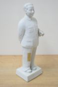 A Chinese Cultural Revolution bisque porcelain figure of liu Shaoqi, modelled standing holding a