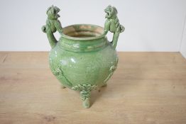 A Chinese Longquan type green/celadon glazed pottery censor, of globular form with foo dog 'handles'