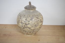 A Chinese Cizhou-style carved pottery jar and cover, of globular form, carved with lotus border