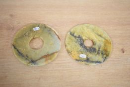 A pair of Chinese carved variegated stone Bi/Yubi type discs, of circular form with central