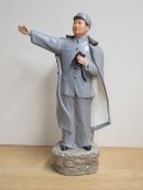 A Chinese Maoist/Cultural revolution porcelain figure of Chairman Mao Zedong, modelled standing with