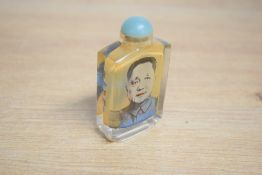 A Chinese reverse decorated glass scent bottle, of traditional design and decorated with an image of