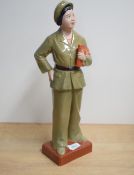 A Chinese cultural revolution glazed bisque porcelain figurine, depicting a female red guard or