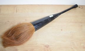 A large Chinese turned ebony calligraphy brush, inscribed with text, 53cm not including brush/