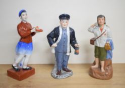 A group of three Chinese cultural revolution/Maoist glazed and part glazed bisque porcelain figures,