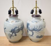 Two Chinese Qing dynasty blue and white pottery wine ewers, each of shouldered baluster form with