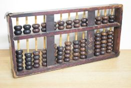 A Chinese hardwood abacus, of traditional design with upper and lower decks and turned 'bead'